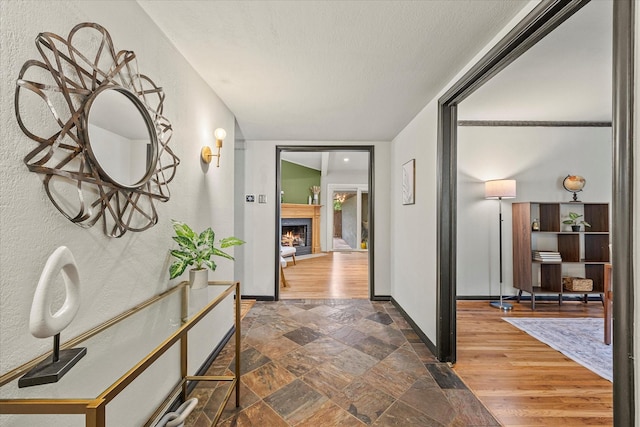 hallway featuring dark hardwood / wood-style flooring and a textured ceiling