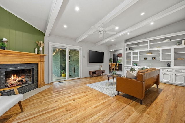 living room featuring ceiling fan, vaulted ceiling with beams, and light wood-type flooring