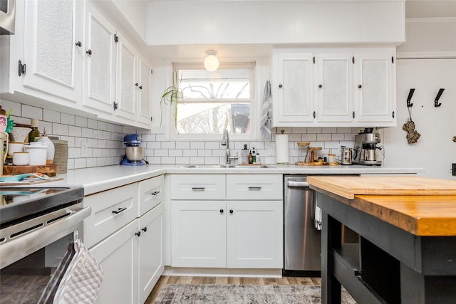 kitchen with white cabinetry, sink, and tasteful backsplash