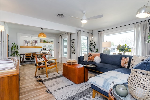 living room featuring ceiling fan and light wood-type flooring