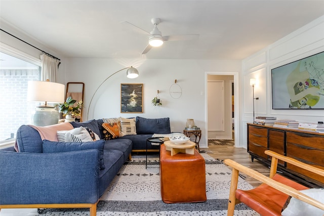 living room with light hardwood / wood-style flooring and ceiling fan