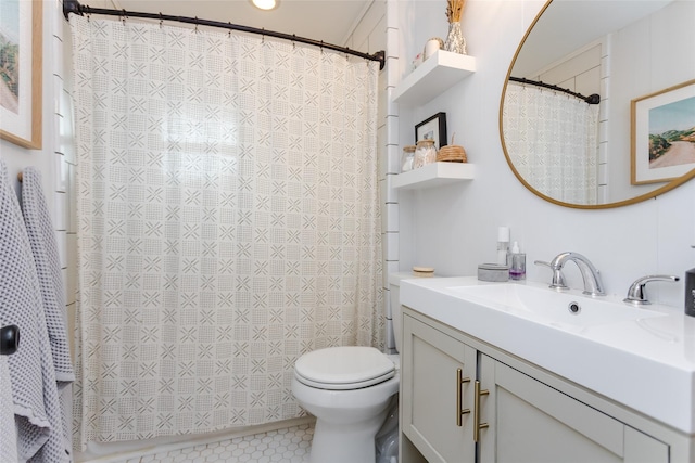 bathroom featuring vanity, toilet, and tile patterned flooring