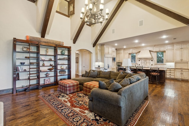 living room with a notable chandelier, beam ceiling, dark hardwood / wood-style floors, and high vaulted ceiling