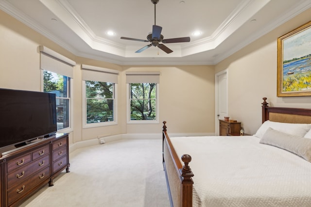 carpeted bedroom featuring ceiling fan, crown molding, and a raised ceiling