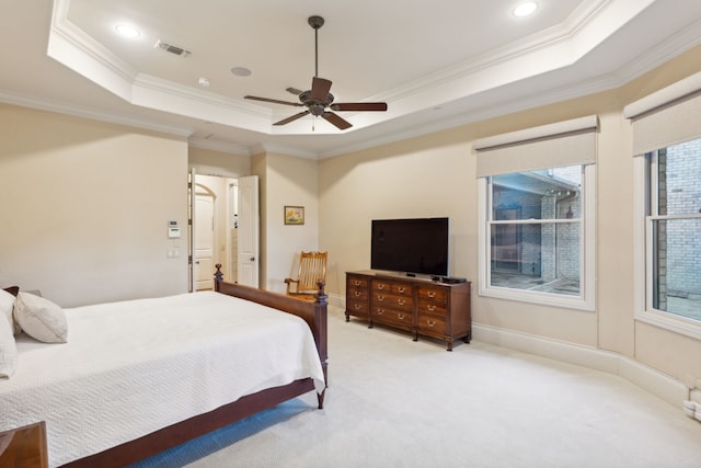 carpeted bedroom featuring a raised ceiling, ceiling fan, and crown molding