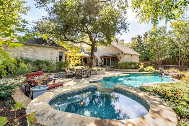 view of swimming pool with a patio area and an in ground hot tub