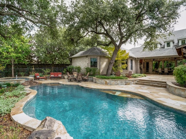 view of swimming pool with an in ground hot tub and a patio area