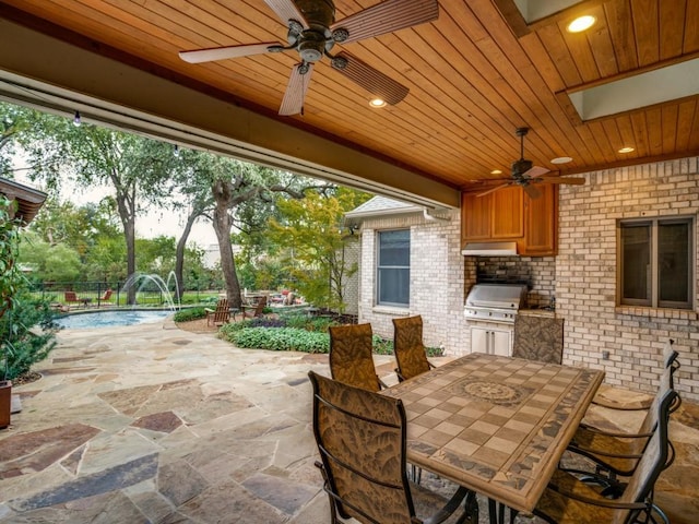 view of patio featuring pool water feature, ceiling fan, a grill, and area for grilling