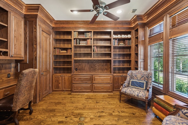 living area with ceiling fan, hardwood / wood-style flooring, and crown molding