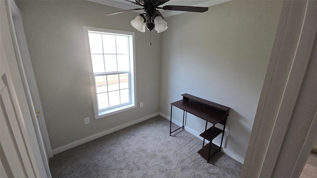 carpeted home office with ceiling fan and a healthy amount of sunlight