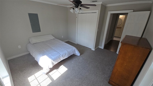 carpeted bedroom with ceiling fan, ornamental molding, a closet, and electric panel