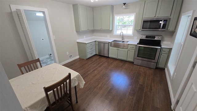 kitchen with dark wood-type flooring, sink, and appliances with stainless steel finishes