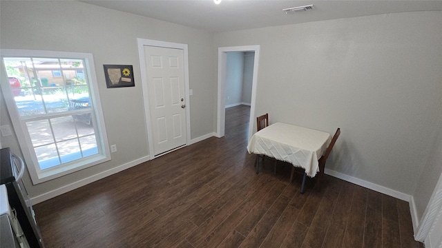 dining room featuring a wealth of natural light and dark hardwood / wood-style flooring