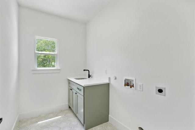 washroom featuring electric dryer hookup, sink, hookup for a washing machine, gas dryer hookup, and cabinets