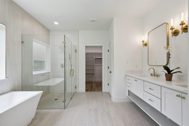 bathroom featuring vanity and shower with separate bathtub