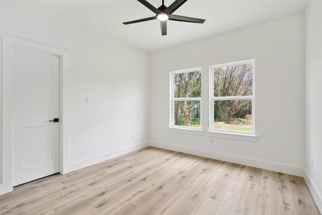 empty room with ceiling fan and light hardwood / wood-style flooring