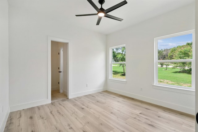 empty room featuring light wood-type flooring and ceiling fan