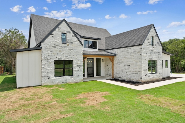 rear view of house featuring a lawn