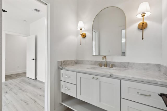 bathroom with vanity and hardwood / wood-style flooring