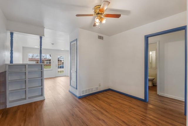 empty room with ceiling fan and hardwood / wood-style floors