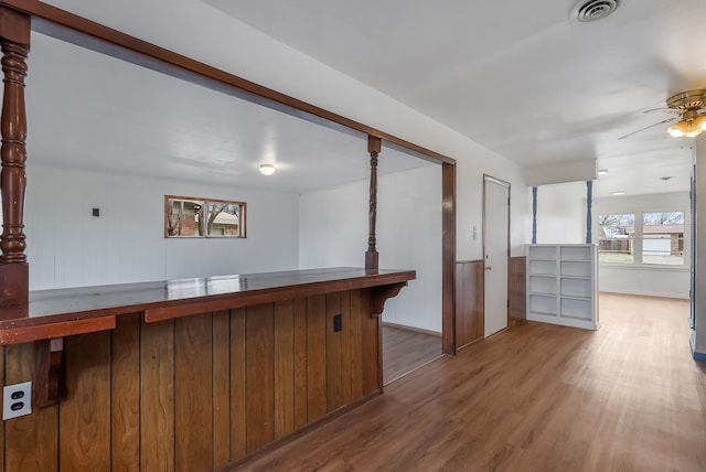 bar featuring hardwood / wood-style flooring and ceiling fan