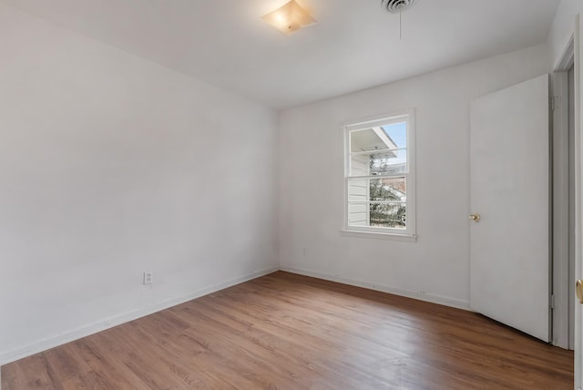 unfurnished room with light hardwood / wood-style floors