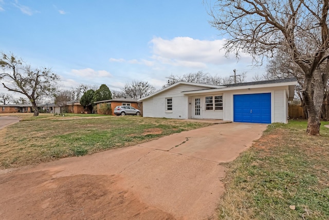 ranch-style home featuring a garage and a front lawn