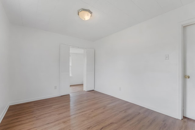 unfurnished room with light hardwood / wood-style floors