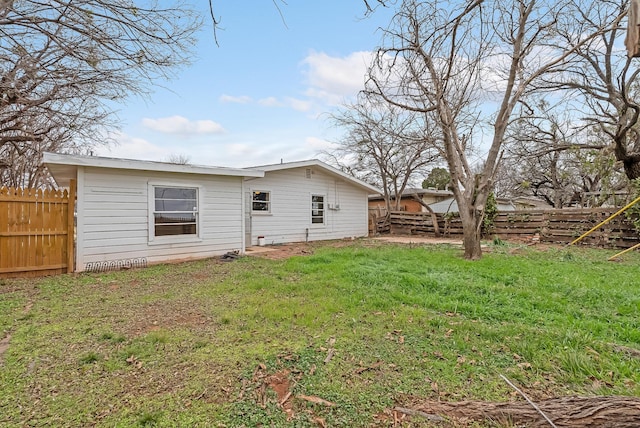 rear view of house featuring a yard