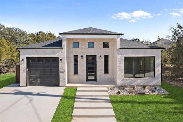 view of front of home featuring a garage and a front lawn