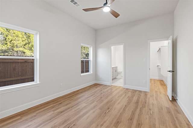 unfurnished bedroom featuring light wood-type flooring, ceiling fan, and ensuite bathroom