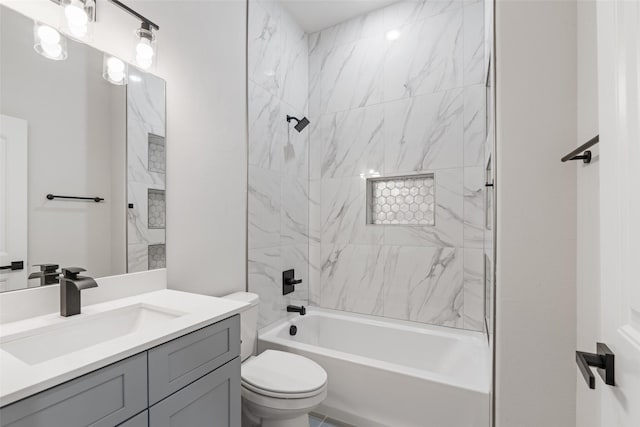 full bathroom with tiled shower / bath combo, vanity, and toilet