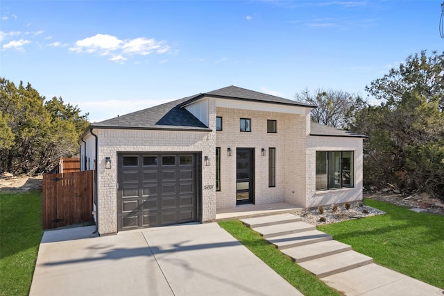 view of front facade with a front yard and a garage