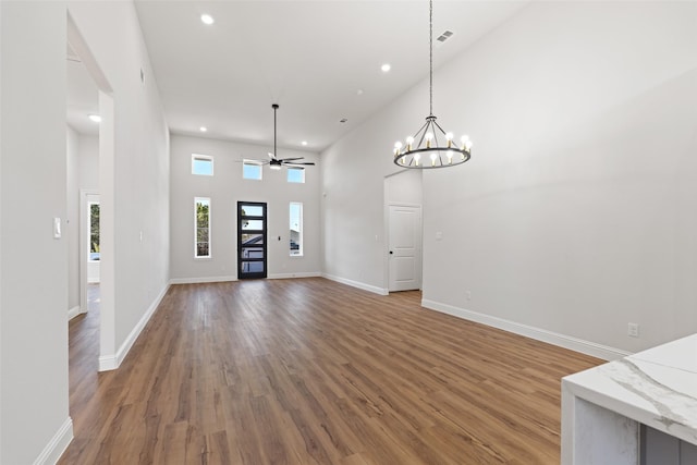 entryway featuring ceiling fan, a towering ceiling, and hardwood / wood-style floors