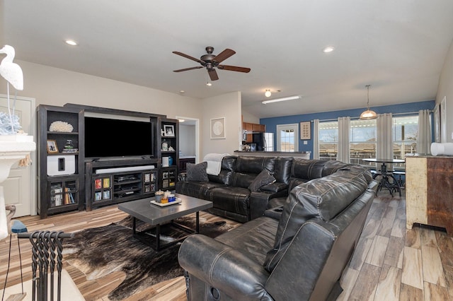 living room featuring ceiling fan and light wood-type flooring