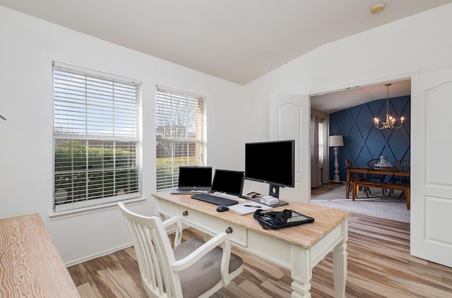 office featuring lofted ceiling, wood-type flooring, and a notable chandelier