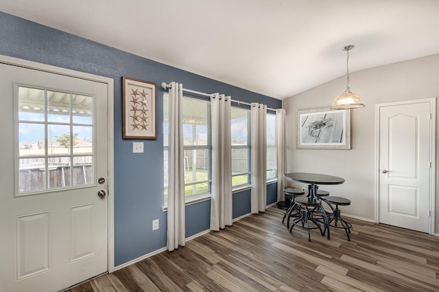 dining room featuring dark hardwood / wood-style flooring and lofted ceiling