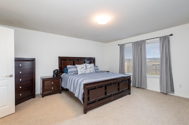 bedroom featuring light carpet