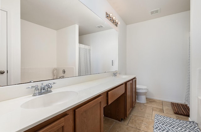 bathroom featuring toilet and vanity