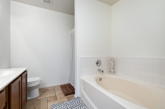 bathroom featuring toilet, a bathtub, and vanity