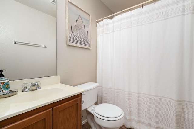 bathroom featuring toilet and vanity