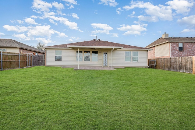 back of property featuring a patio area and a yard