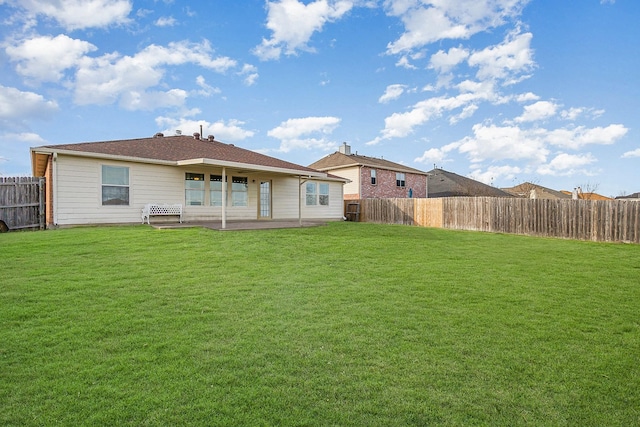 rear view of property featuring a patio area and a yard