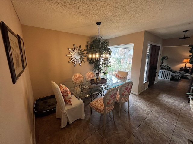 dining room with a textured ceiling and an inviting chandelier