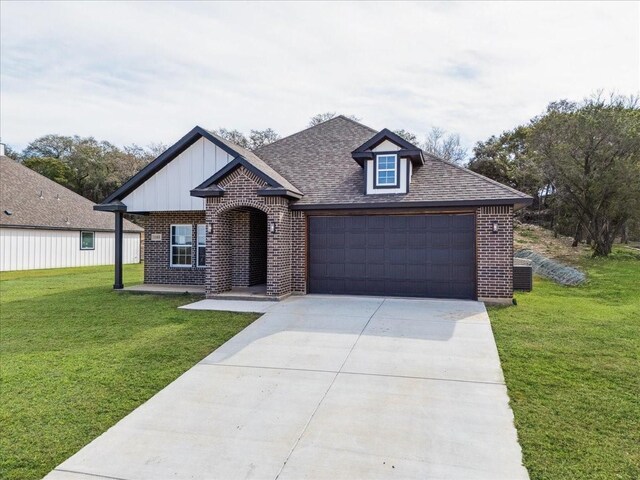 view of front of property with a front yard and a garage