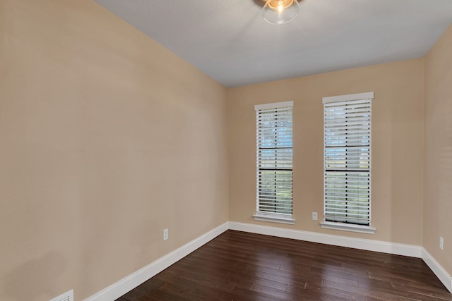 spare room featuring dark hardwood / wood-style floors