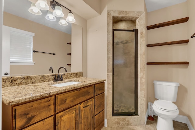 bathroom with a shower with shower door, vanity, and toilet