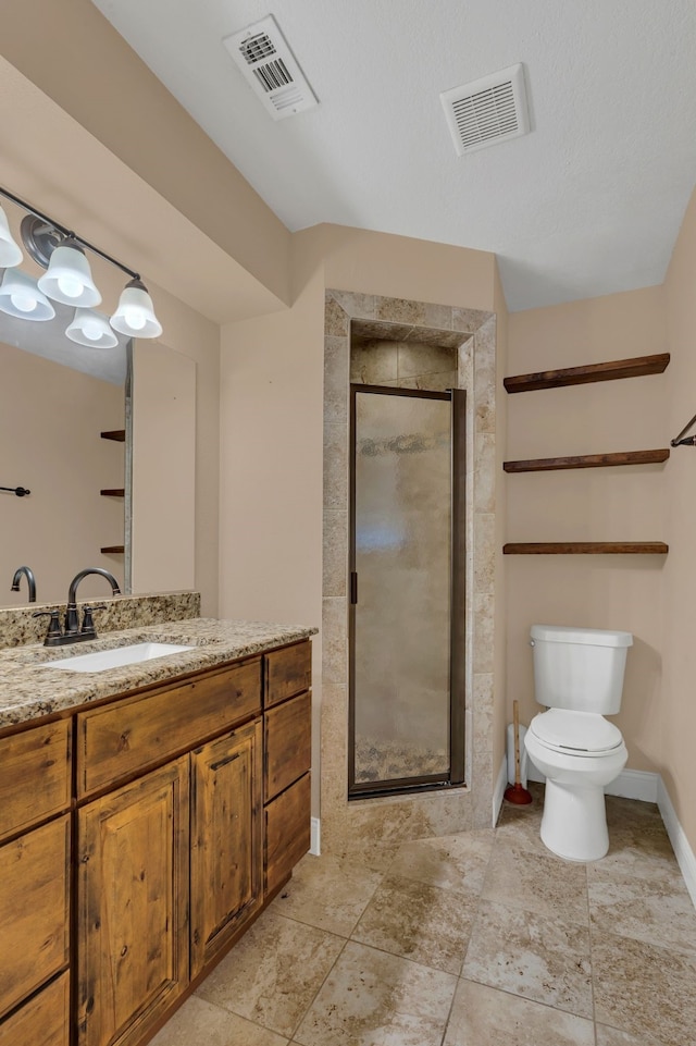 bathroom featuring an enclosed shower, vanity, and toilet