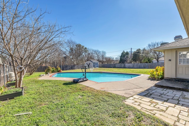 view of swimming pool featuring a shed, a lawn, and a patio