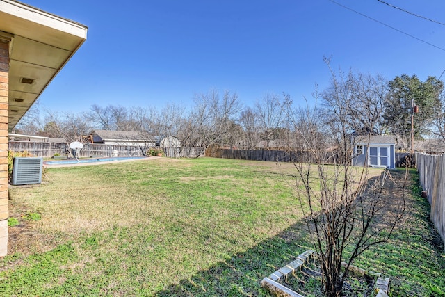 view of yard with a fenced in pool, cooling unit, and a storage unit